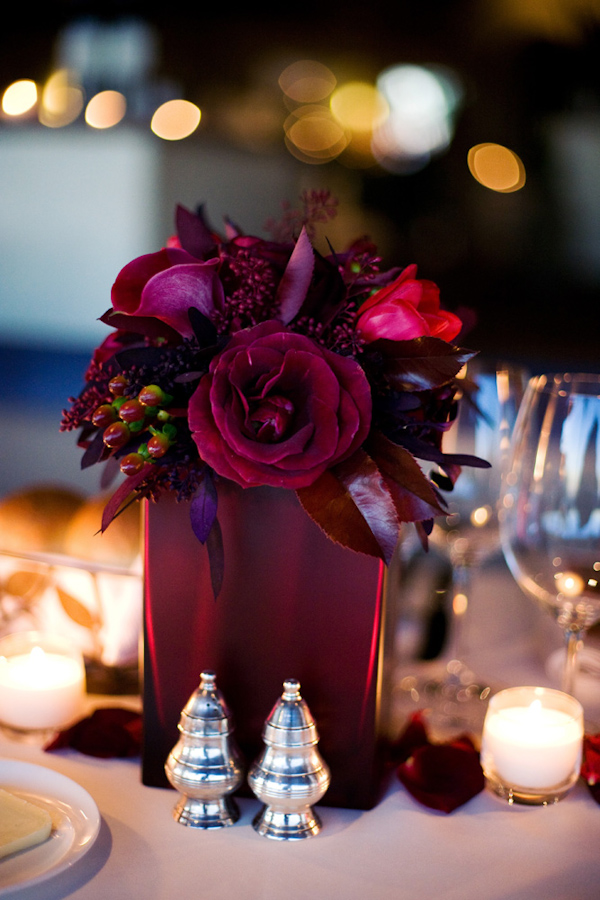 modern dark-red rose centerpiece with berries -  photo by Melissa Jill Photography